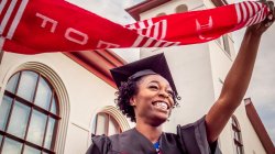 Student waving EOF stole at graduation