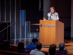 Mimi Feliciano speaking at a podium