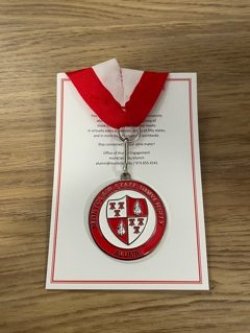 Photo of Commemorative Zipper Pull with a red and white ribbon