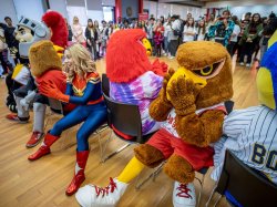 Rocky and costumed characters playing musical chairs