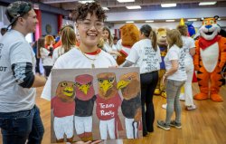 student holding painting of team rocky