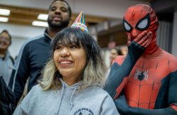 Girl smiling with Spider-Man behind her