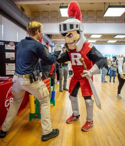 Arm wrestling The Scarlet Knight from Rutgers.