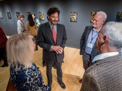 University President Jonathan Koppell speaks with President's Club members at the Segal Gallery.
