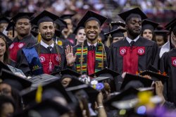 Three graduates at commencement