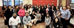 Large group poses for photo at Hispanic networking event.