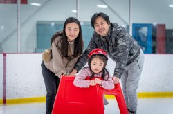 Couple ice skating with child