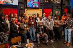 Large group gathered inside a cheerful pub.