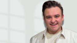 smiling man in white shirt