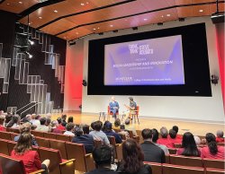 Photograph of a lecture hall with a presentation about TV and media