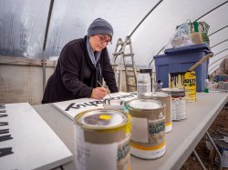 Meryem Teke, a senior Religion major, paints a garden sign at the Munsee Three Sisters Farm. The work is among the creative ways Montclair is supporting the Turtle Clan’s language revitalization and environmental recovery.