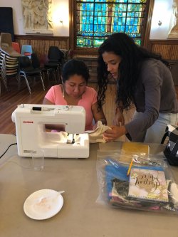 Students Volunteering, instructing on sewing techniques for Sewing Angels