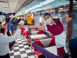 Students in face masks rehearse Working in the Red Hawk Diner
