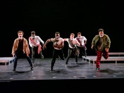 Dancers on stage with face masks