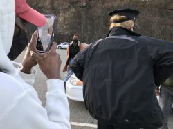 Young person using video conferenceing to record a police officer