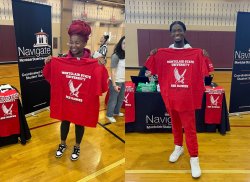 Shaniqua Williams and Jared Bailey proudly hold College of the Arts tee-shirts after declaring their majors.