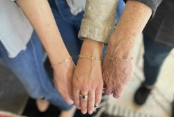 Image of 3 wrists wearing permanent bracelets