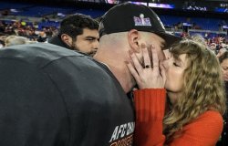 Taylor Swift kisses Kansas City Chiefs tight end Travis Kelce after an AFC Championship NFL football game against the Baltimore Ravens, Sunday, Jan. 28, 2024, in Baltimore. The Kansas City Chiefs won 17-10. (AP Photo/Julio Cortez)