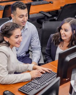 three students gathered at computer