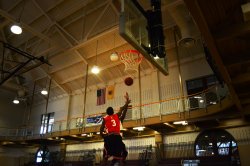 Two club basketball players going up for a shot in the basketball hoop
