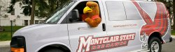 Rocky the Red Hawk in a Montclair State van