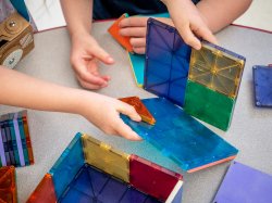 Photo of children playing with magnatiles.