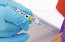 A health worker giving the flu shot