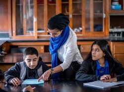Photo of young teacher with students.
