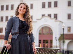 Graduate student standing outside the Feliciano School of Business at Montclair State