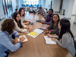 Students gathered around a table on campus at Montclair State