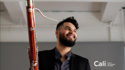 Smiling man holding bassoon