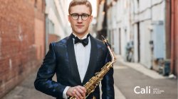 Saxophonist in alley in tuxedo