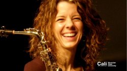 Woman laughing with saxophone