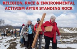 Photo Credit: Dave Parry. Photo of activists carrying a wooden cross outside. snow and dirt is on the ground with cloudy sky