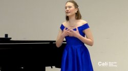 Woman in Blue Dress on Stage Performing