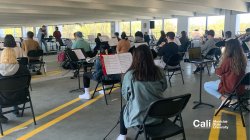 Flutist Playing in Parking Garage with Large Ensemble