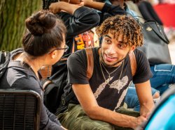 Photo of two students in Student Center Quad conversing.