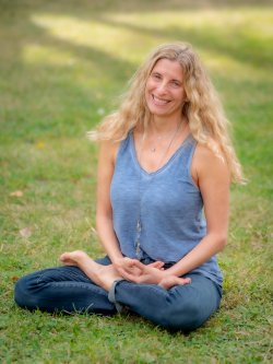 Photo of Dr. Elizabeth Erwin seated in the Lotus pose.