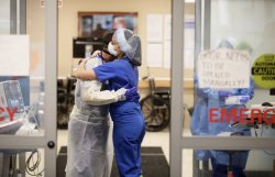 Jim Abaze and nurse Nicole Kilgallen embrace in the emergency room entrance at Hackensack University Medical Center, which treated the first N.J. COVID-19 patient, in Hackensack, N.J. Ed Murray | NJ Advance Media