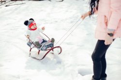 Child on sled with mom
