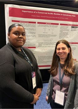 student and advisor by their poster during the ASBMB Meeting