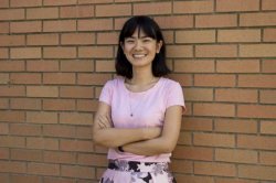 Photo of Professor Jennifer Yang standing in front of a brick wall