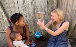 Cortni Borgerson holding an insect in a cup