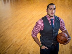 Gian Paul Gonzales stands on a basketball court with a basketball in one arm