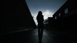 Photo of woman in dark alley