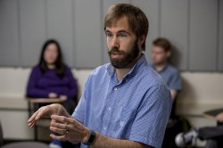 Professor Jonathan Howell in a classroom, lecturing to students