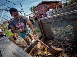 Richard Steiner-Otoo, a junior majoring in Geographic, Environmental and Urban Studies, turns a compost pile at Down Bottom Farms. The site has evolved from an abandoned and contaminated freight rail yard into a community asset that promotes sustainability and food justice.