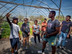 Christian Rodriguez, urban agriculture manager at Down Bottom Farms, leads Montclair students on a tour of the garden. Among the group, graduate students Leanna Sanchez ’22, second from left, and Krishna Polius, third from left, are part of the Anthropology class that explores solutions to building sustainable communities.
