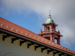 photo of blue sky and mission tile roof with Cole Hall bell tower
