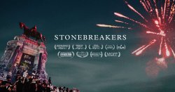 Image from the movie Stonebreakers with fireworks and a monument in the background